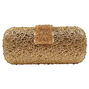 Detail view of the golden evening clutch featuring sparkling rhinestones and metal buckle