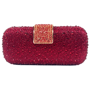 Close-up of luxury rectangular evening clutch bag covered in ruby red rhinestones