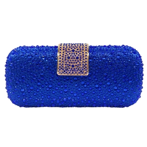 Macro detail of navy blue luxury evening clutch bag with sparkling rhinestone crystals