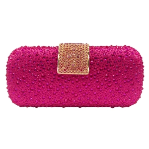 Detail of rose pink clutch bag featuring full rhinestone surface and golden metal buckle