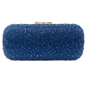 Detailed view of dark blue rectangular evening clutch with dense shimmering rhinestones