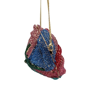 Close-up of colorful rhinestones on a geometric evening bag with a gold chain