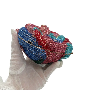 Macro detail of multi-color crystal rhinestones on luxury flower-shaped evening clutch bag