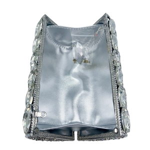 Silver crystal cylinder evening bag showing interior compartment and rhinestone details