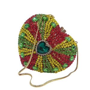 Luxurious heart-shaped dinner clutch with multicolored crystals and a green gemstone