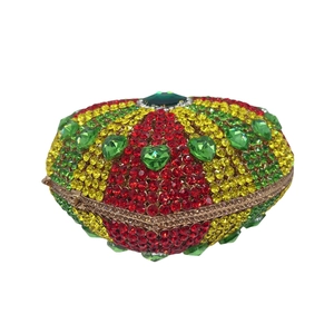 Detailed view of heart evening bag with red yellow green crystals and gold frame