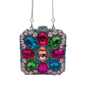 Detail of evening clutch bag featuring vibrant multi-colored crystals and silver chain strap