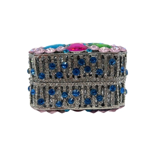 Detail of hollow out clutch bag with pink crystal and colorful rhinestones