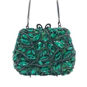 Close-up of emerald green crystal evening clutch with leaf patterns and silver chain