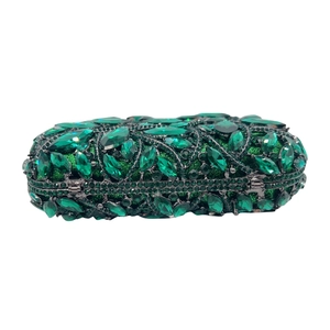 Detail of emerald green crystal leaf cluster patterns on a luxury bridal clutch bag