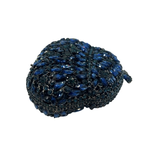Detailed view of heart-shaped clutch bag with blue and black crystals and metal frame