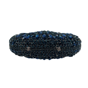 Macro detail of luxury navy blue crystal clutch with intricate rhinestone embellishments