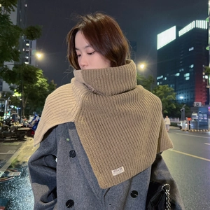 Detail of chunky two-tone knit turtle neck cowl shawl in coffee brown with brand tag