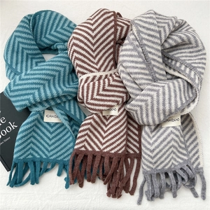 Winter knitted scarves with chevron pattern and fringes in blue, brown and grey colors
