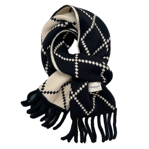 Soft knit winter scarf with black and white diamond pattern and fringe tassels