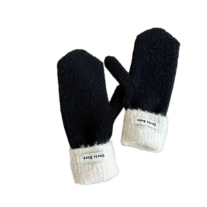 Winter thermal knit mittens with black fabric and white faux fur cuffs and brand label