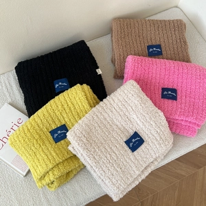 Thick knit winter scarves in five colors featuring vertical ribs and brand labels