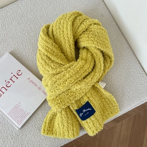 Detail of yellow coral fleece scarf showing soft texture and navy brand label