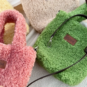 Flat lay of colorful plush crossbody bags in pink, green, beige and yellow hues