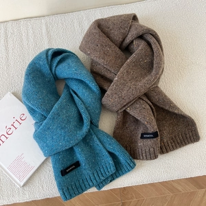 Detail of wool knit scarves in grey-blue and dark brown with marl speckled texture