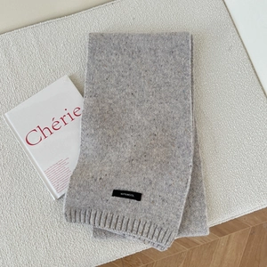 Detail view of 100% pure wool knitted scarf in oatmeal grey with soft ribbed edges