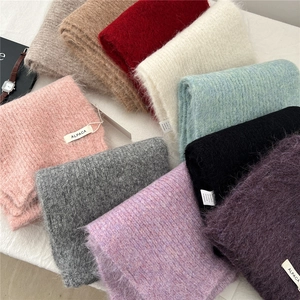 Detail of alpaca wool blend scarf showing assorted colors and fabric composition tags