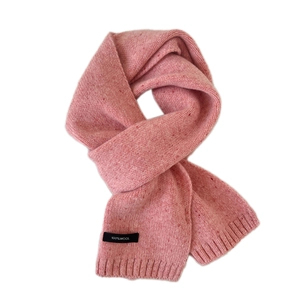 Thick pink knit wool scarf for winter warmth with a ribbed edge finish on white background