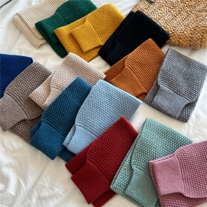 Chunky knit waffle scarves in various colors with ribbed edges for winter warmth