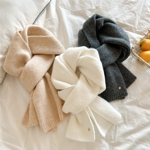 Three warm knit scarves in beige, white, and dark grey with decorative gold metal buttons