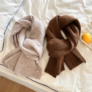 Soft knit winter scarves in oat and brown colors featuring unique metal button details