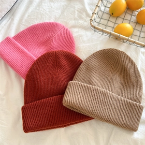 Thick knitted winter beanies for women in pink, brick red and khaki with ribbed texture