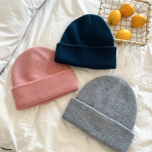 Thick knitted beanie hats for women in pink, navy, and grey colors with ribbed texture