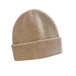 Thick warm winter knitted beanie in oatmeal color with vertical ribbed knit and cuff