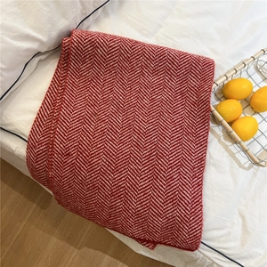 Detail of red and white herringbone knit pattern on a thick warm winter scarf