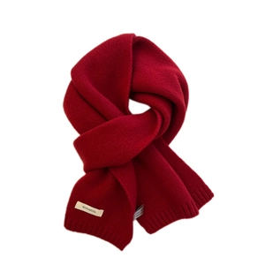 Classic deep red 100% wool knitted winter scarf with ribbed edges and soft texture
