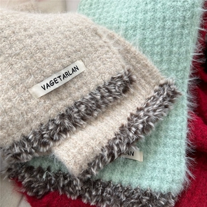 Detail of soft knit scarf with leopard faux fur trim and VAGETARLAN label