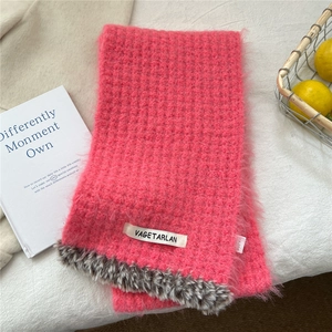 Detail of bright pink knitted scarf with fuzzy texture and leopard print faux fur trim