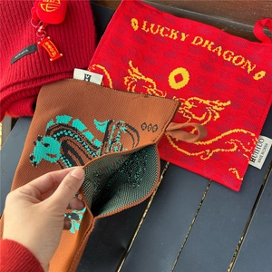 Detail showing 100% wool knitted texture and lucky dragon pattern on the tissue cover