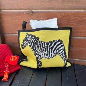 Knitted yellow tissue bag with zebra pattern and Chinese New Year festive decorations