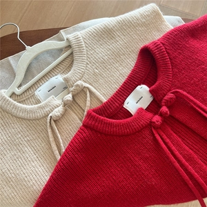 Solid knit knot shawl with woven button closure in red and beige colors