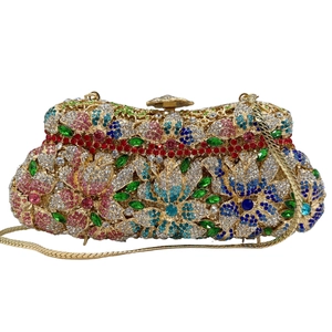 Detailed macro view of colorful floral rhinestone stone clutch with gold chain