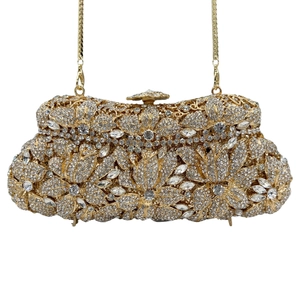 Close-up of crystal flower patterns and metal frame on a luxury evening stone clutch