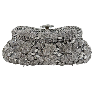 Close-up of sparkling silver floral crystal embellishments and vintage metal flower clasp
