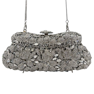 Detail of silver evening clutch with floral crystal patterns and metal chain strap