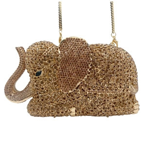 Macro detail of elephant evening clutch bag with champagne crystals and golden chain
