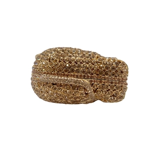Detailed macro of champagne gold hollow elephant evening bag with sparkling crystals
