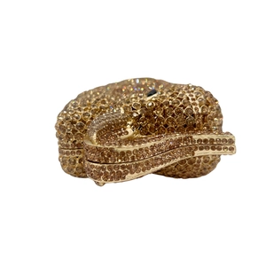 Detail of golden elephant evening bag with intricate crystal embellishments and metal frame