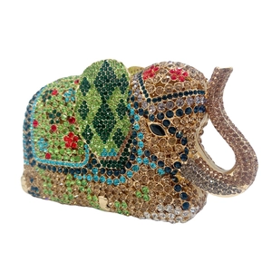 Detailed macro view of colorful crystals and intricate patterns on an elephant clutch bag