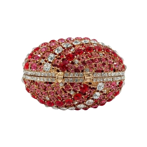 Detailed view of oval evening clutch with red and pink rhinestones in a gold metal frame