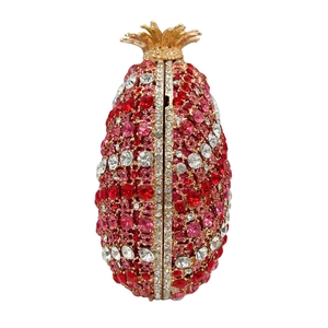Sparkling pineapple shaped evening clutch bag with red crystals and gold metal leaf handle